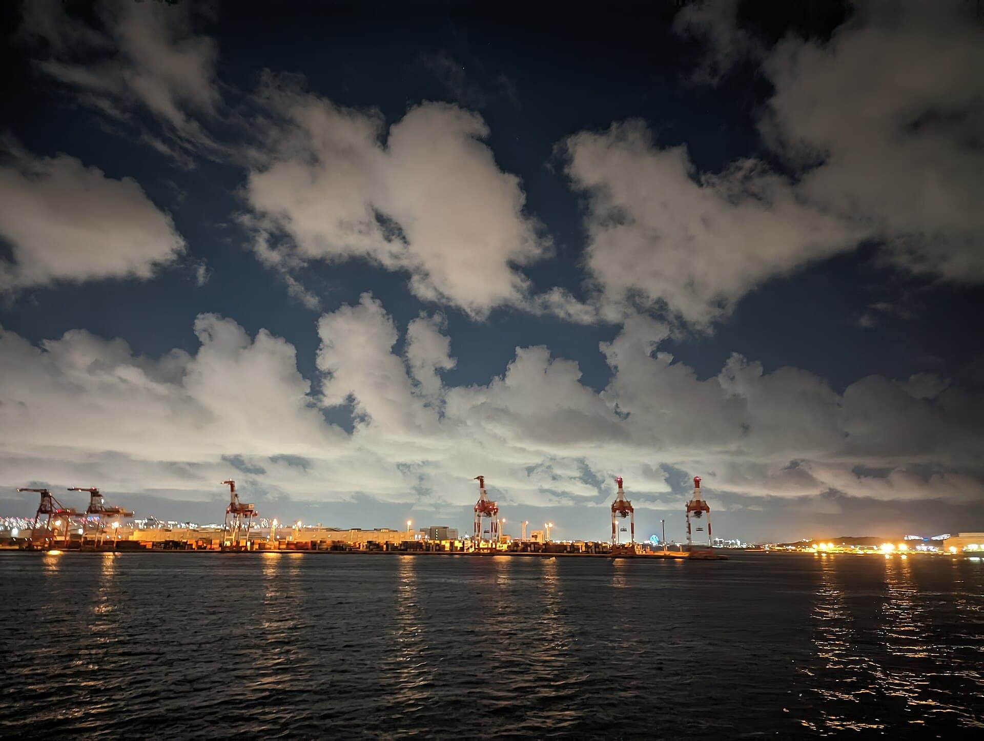 Container port cranes lit at night